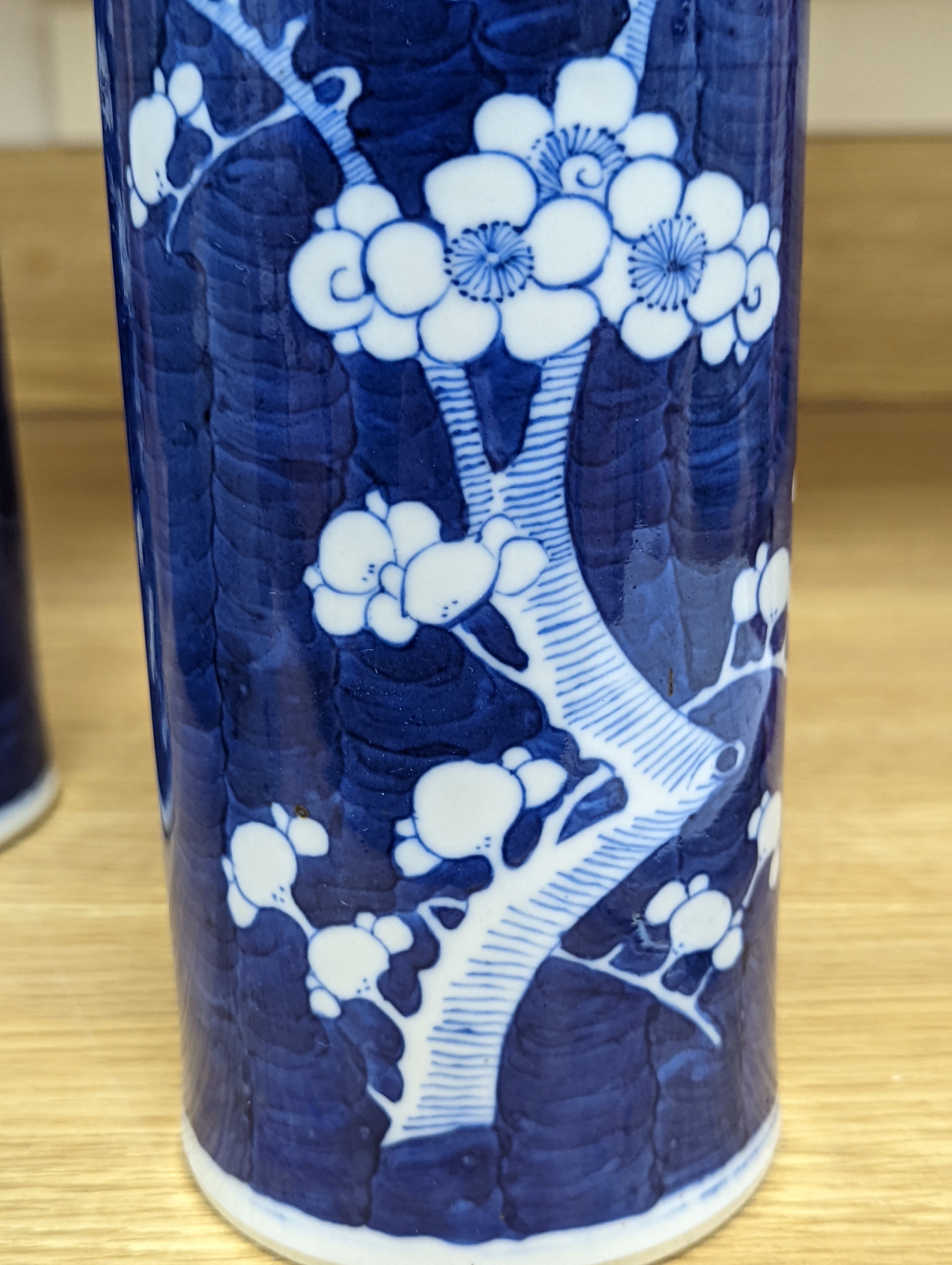 An 18th century Chinese famille rose mug, a Chinese Imari tea caddy and two Chinese blue and white sleeve vases 30cm (4)